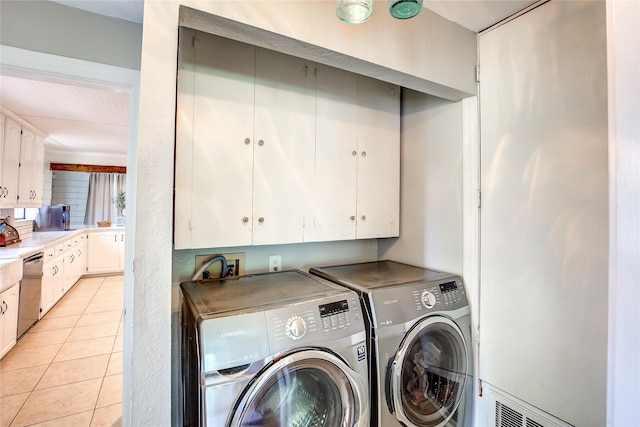 929 Church St, Sulphur Springs, TX 75482 - laundry area with washer and clothes dryer, cabinet space, and light tile patterned floors