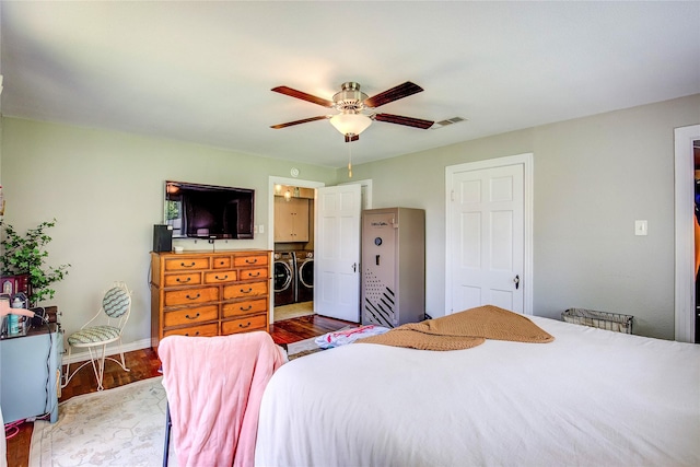 929 Church St, Sulphur Springs, TX 75482 - bedroom with washing machine and dryer, wood finished floors, and a ceiling fan