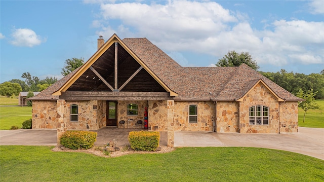 4555 Farm Rd Unit 1402, Mount Pleasant, TX 75455 - tudor home with stone siding, a chimney, a front yard, and roof with shingles