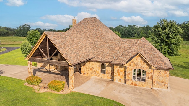 4555 Farm Rd Unit 1402, Mount Pleasant, TX 75455 - view of front of home with stone siding, a chimney, and a front lawn