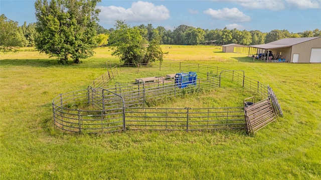 4555 Farm Rd Unit 1402, Mount Pleasant, TX 75455 - view of yard with a view of countryside, a pole building, a detached garage, and an outbuilding