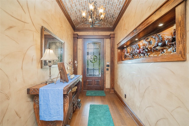4555 Farm Rd Unit 1402, Mount Pleasant, TX 75455 - entryway featuring a chandelier, lofted ceiling, crown molding, brick ceiling, and wood-type flooring