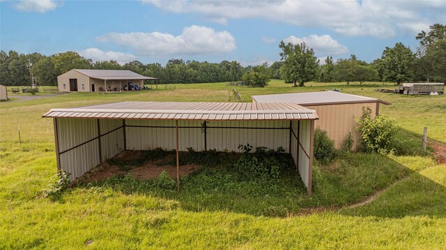 4555 Farm Rd Unit 1402, Mount Pleasant, TX 75455 - view of pole building with a detached carport, a lawn, and a rural view