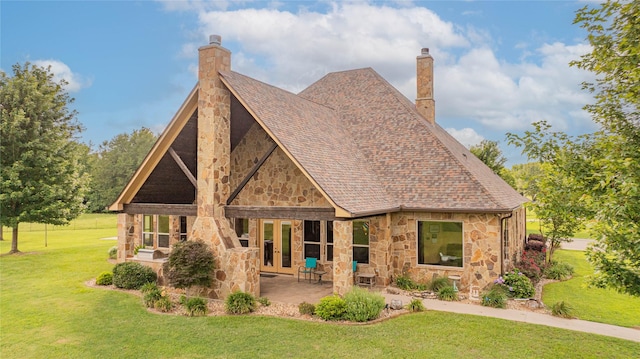 4555 Farm Rd Unit 1402, Mount Pleasant, TX 75455 - rear view of house with stone siding, a chimney, a lawn, french doors, and a patio