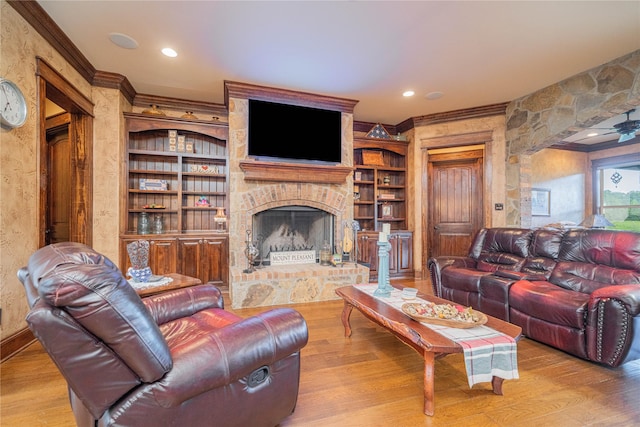 4555 Farm Rd Unit 1402, Mount Pleasant, TX 75455 - living room with ornamental molding, a large fireplace, wood finished floors, ceiling fan, and built in features