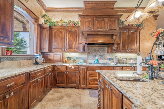 4555 Farm Rd Unit 1402, Mount Pleasant, TX 75455 - kitchen featuring tasteful backsplash, light stone countertops, ornamental molding, and pendant lighting