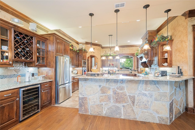4555 Farm Rd Unit 1402, Mount Pleasant, TX 75455 - kitchen featuring appliances with stainless steel finishes, wine cooler, open shelves, glass insert cabinets, and light stone countertops