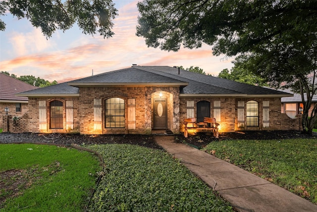 3302 Oxford Dr, Rowlett, TX 75088 - view of front facade featuring a lawn, brick siding, and a shingled roof
