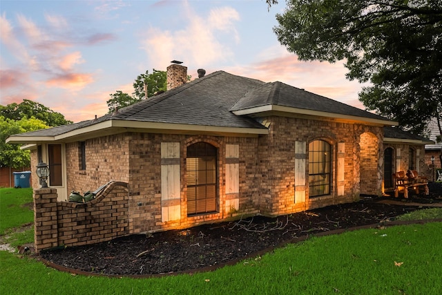 3302 Oxford Dr, Rowlett, TX 75088 - view of front of home featuring a chimney, brick siding, a shingled roof, and a lawn