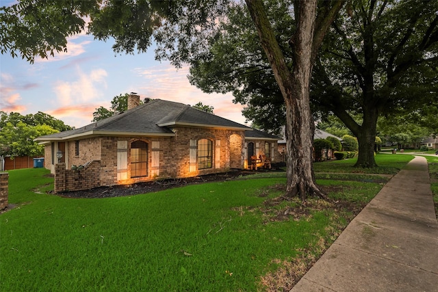 3302 Oxford Dr, Rowlett, TX 75088 - view of front facade with a front yard, a chimney, and brick siding