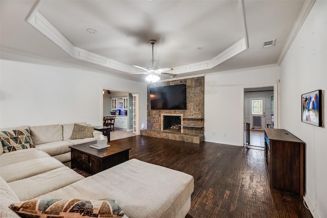 3302 Oxford Dr, Rowlett, TX 75088 - living room featuring a raised ceiling, wood finished floors, crown molding, a fireplace, and ceiling fan