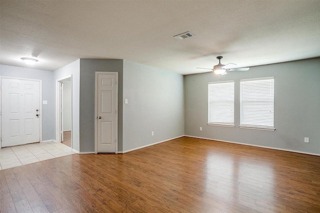 1347 Hillside Dr, Burleson, TX 76028 - spare room with a ceiling fan, light wood finished floors, and a textured ceiling