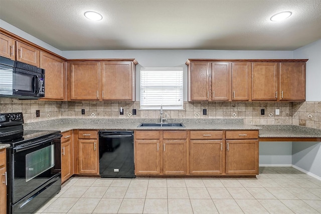 1347 Hillside Dr, Burleson, TX 76028 - kitchen featuring black appliances, tasteful backsplash, and brown cabinetry