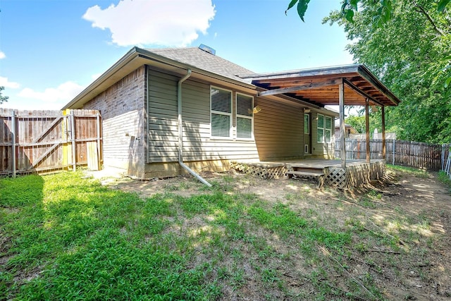 1347 Hillside Dr, Burleson, TX 76028 - rear view of house with a fenced backyard, a deck, and a shingled roof