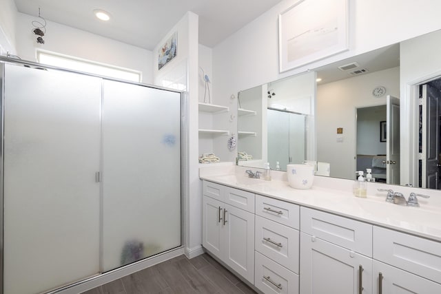 9657 Alderleaf Trl, Fort Worth, TX 76036 - bathroom featuring a stall shower, double vanity, and wood finished floors