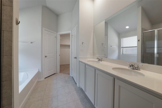 4205 Cordata Dr, Melissa, TX 75454 - bathroom featuring a shower stall, a bath, double vanity, tile patterned floors, and a spacious closet