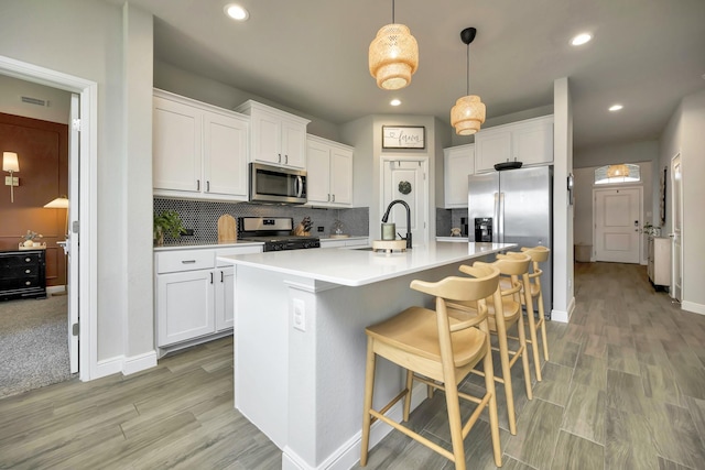 2305 Waggoner Ranch Dr, Weatherford, TX 76087 - kitchen featuring appliances with stainless steel finishes, light wood-style floors, backsplash, and recessed lighting