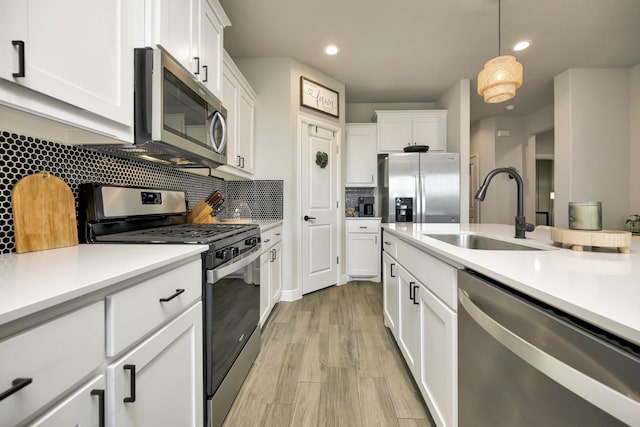 2305 Waggoner Ranch Dr, Weatherford, TX 76087 - kitchen featuring stainless steel appliances, light countertops, white cabinetry, decorative backsplash, and recessed lighting