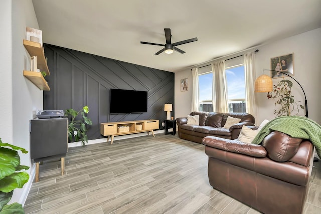 2305 Waggoner Ranch Dr, Weatherford, TX 76087 - living area featuring ceiling fan, light wood finished floors, a decorative wall, and an accent wall