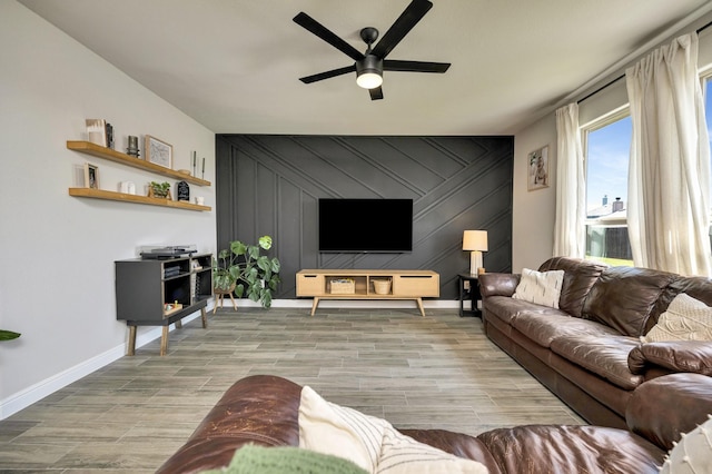 2305 Waggoner Ranch Dr, Weatherford, TX 76087 - living area featuring a ceiling fan, wood finished floors, and an accent wall