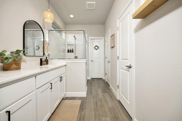 2305 Waggoner Ranch Dr, Weatherford, TX 76087 - full bath featuring double vanity, a shower stall, and wood finished floors