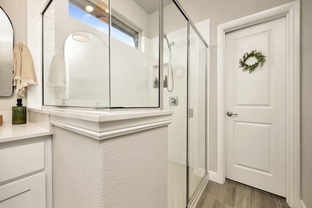 2305 Waggoner Ranch Dr, Weatherford, TX 76087 - bathroom with a shower stall, wood finished floors, and vanity