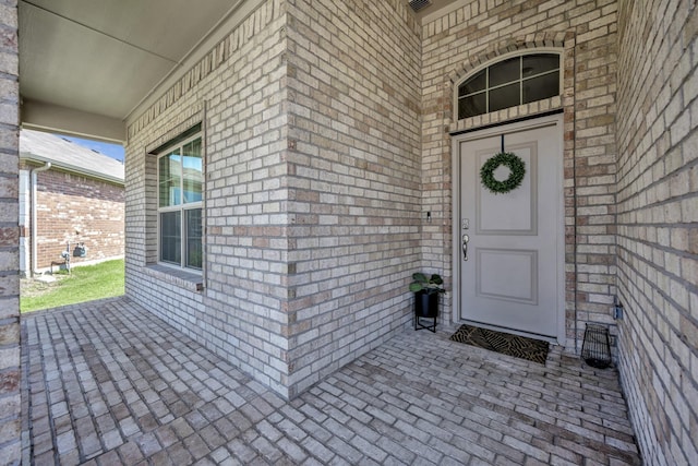 2305 Waggoner Ranch Dr, Weatherford, TX 76087 - doorway to property with brick siding and a porch