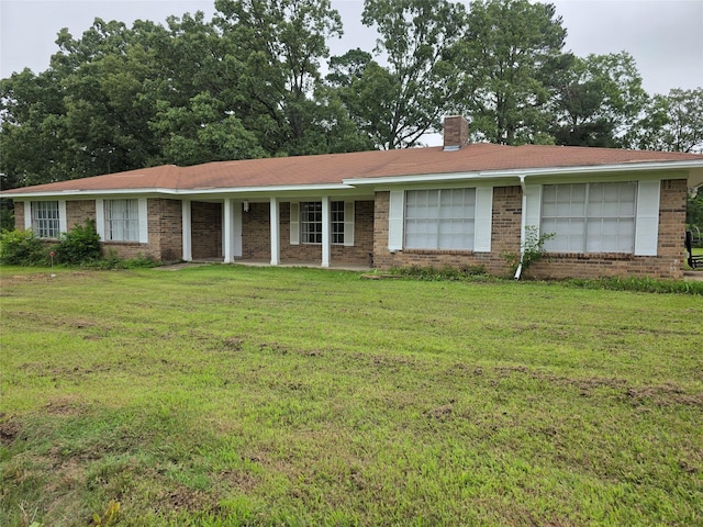 191 44e, De Kalb, TX 75559 - single story home featuring brick siding, a front yard, and a chimney