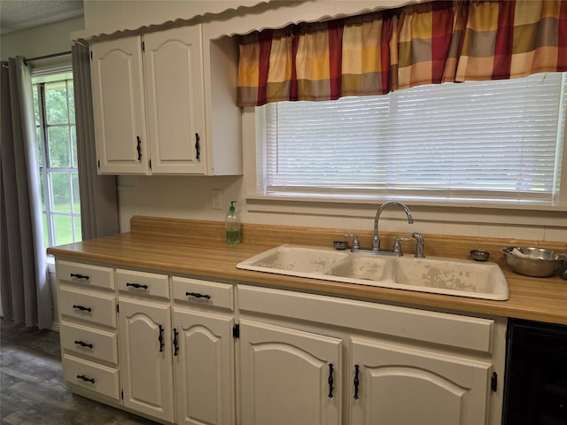 191 44e, De Kalb, TX 75559 - kitchen featuring white cabinetry, dark wood-type flooring, dishwasher, and light countertops