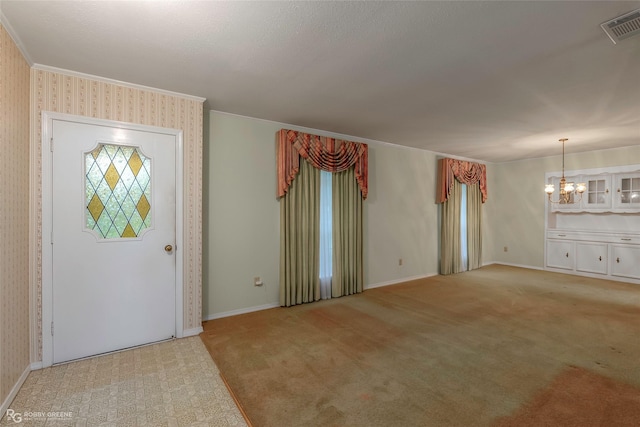 189 India Dr, Shreveport, LA 71115 - entryway featuring a chandelier, light carpet, ornamental molding, and wallpapered walls