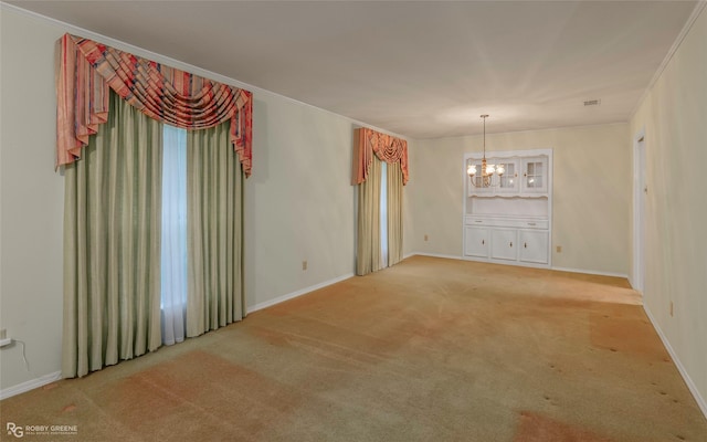 189 India Dr, Shreveport, LA 71115 - empty room featuring a chandelier, light colored carpet, and crown molding