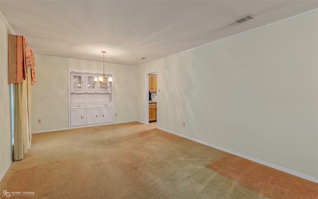 189 India Dr, Shreveport, LA 71115 - empty room featuring a chandelier, light colored carpet, and crown molding