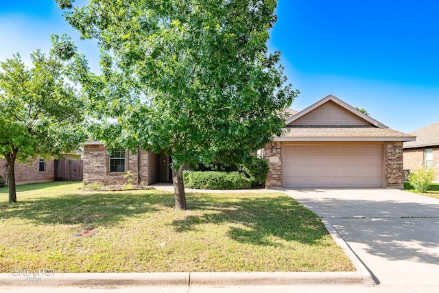 217 Sugarloaf Ave, Abilene, TX 79602 - view of property hidden behind natural elements with brick siding, a front yard, driveway, a garage, and a shingled roof