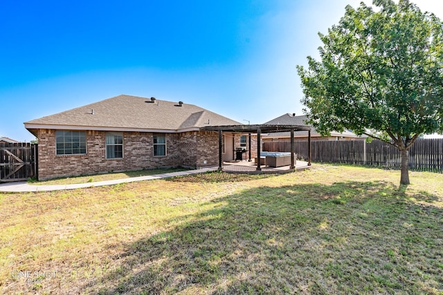 217 Sugarloaf Ave, Abilene, TX 79602 - back of property with a hot tub, a fenced backyard, brick siding, and a patio area
