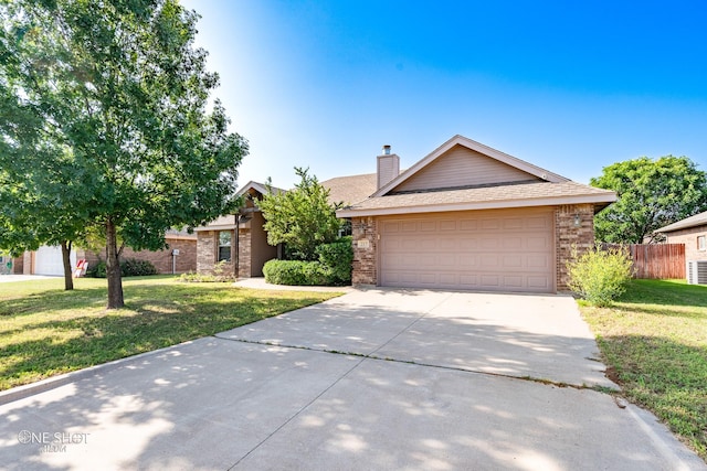 217 Sugarloaf Ave, Abilene, TX 79602 - view of front facade featuring brick siding, concrete driveway, a garage, and roof with shingles