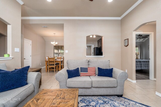 217 Sugarloaf Ave, Abilene, TX 79602 - living room with ceiling fan, tile patterned floors, ornamental molding, arched walkways, and a chandelier