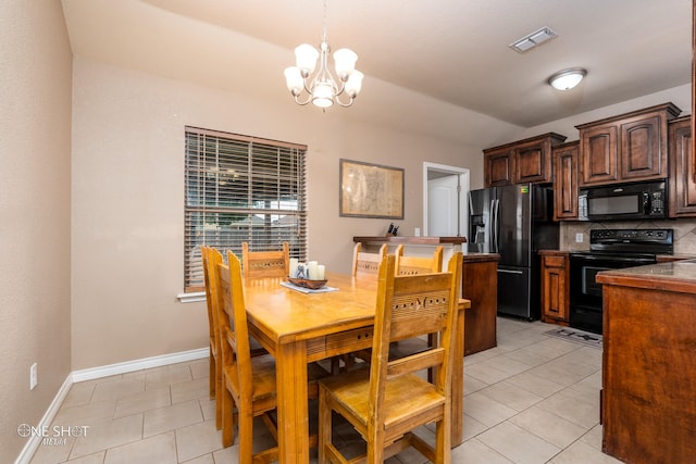 217 Sugarloaf Ave, Abilene, TX 79602 - dining room with a chandelier, vaulted ceiling, and light tile patterned flooring