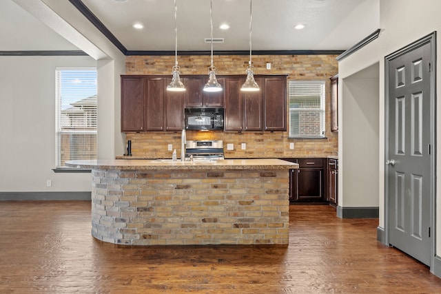682 Cannon Dr, Fate, TX 75087 - kitchen featuring black microwave, stainless steel range oven, ornamental molding, healthy amount of natural light, and dark wood finished floors