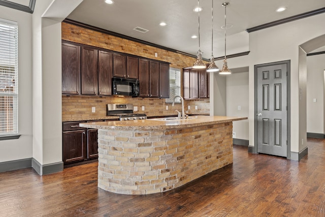 682 Cannon Dr, Fate, TX 75087 - kitchen with black microwave, stainless steel range, dark wood finished floors, backsplash, and crown molding