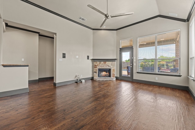 682 Cannon Dr, Fate, TX 75087 - unfurnished living room featuring ornamental molding, a ceiling fan, a stone fireplace, wood finished floors, and vaulted ceiling