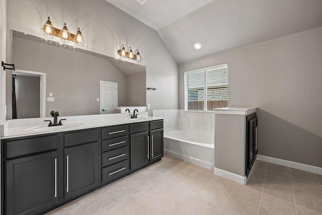 682 Cannon Dr, Fate, TX 75087 - bathroom with lofted ceiling, a garden tub, double vanity, and tile patterned floors