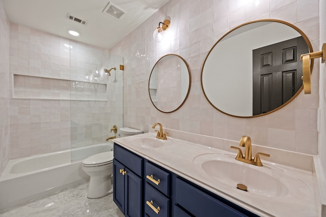 682 Cannon Dr, Fate, TX 75087 - full bathroom with tile walls, tub / shower combination, double vanity, and tasteful backsplash