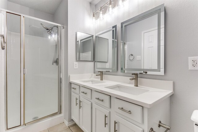 8732 Hunters Trl, Fort Worth, TX 76123 - bathroom featuring a stall shower, double vanity, and tile patterned flooring