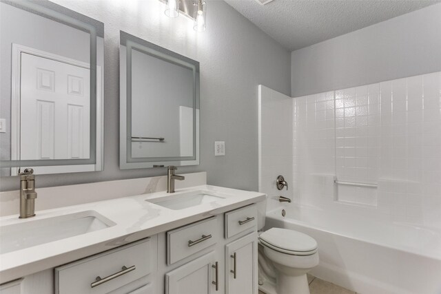 8732 Hunters Trl, Fort Worth, TX 76123 - bathroom with a textured ceiling, double vanity, and shower / bath combination