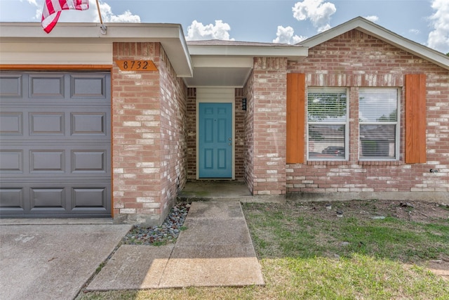 8732 Hunters Trl, Fort Worth, TX 76123 - view of exterior entry featuring brick siding and an attached garage