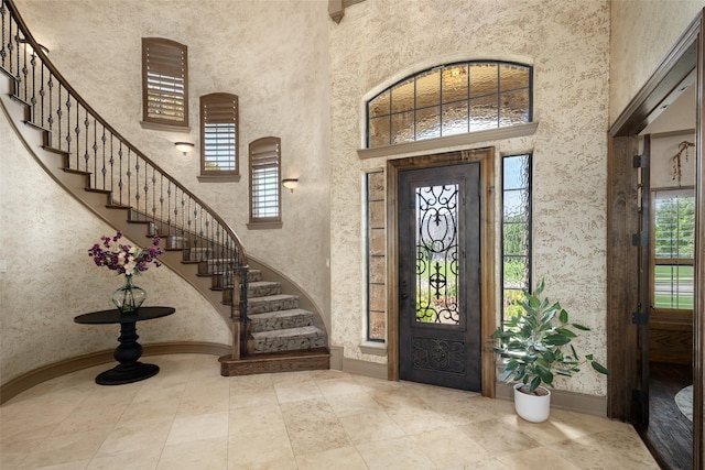 109 Old Vineyard Ln, Heath, TX 75032 - entryway with a high ceiling, healthy amount of natural light, stairway, and tile patterned flooring