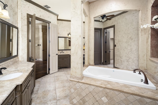 109 Old Vineyard Ln, Heath, TX 75032 - full bathroom with two vanities, a garden tub, ceiling fan, and tile patterned floors
