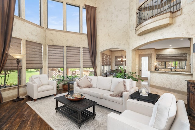 109 Old Vineyard Ln, Heath, TX 75032 - living area featuring a towering ceiling, arched walkways, a chandelier, and healthy amount of natural light