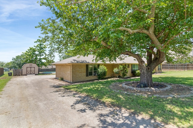 206 S Field St, Prosper, TX 75078 - view of property hidden behind natural elements with a storage unit and brick siding