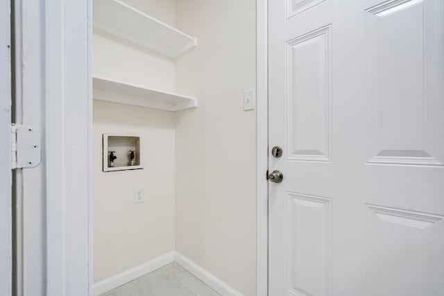 1828 Tracey Cir, Irving, TX 75060 - laundry area with hookup for a washing machine and light marble finish flooring